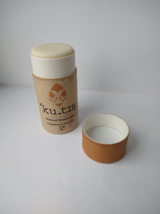 The Grapefruit & Mandarin Kutis stick open, with the lid beside it.