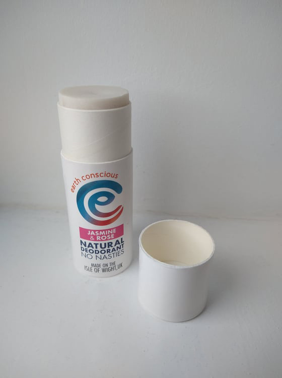 The white cardboard tube of Jasmine & Rose Earth Conscious, with the lid beside it.