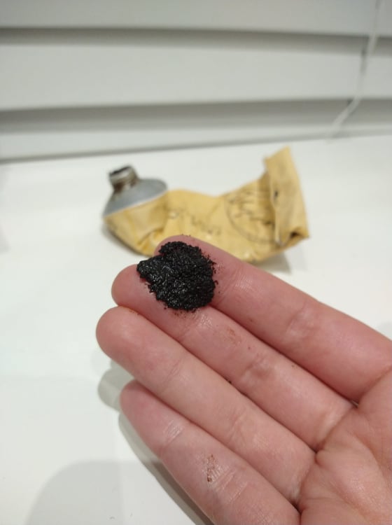 A blob of the Upcircle coffee face scrub smushed on my fingers.