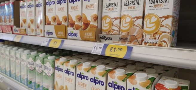 The alternative milks section in Tesco, with several shelves of Alpro and Rice dream.