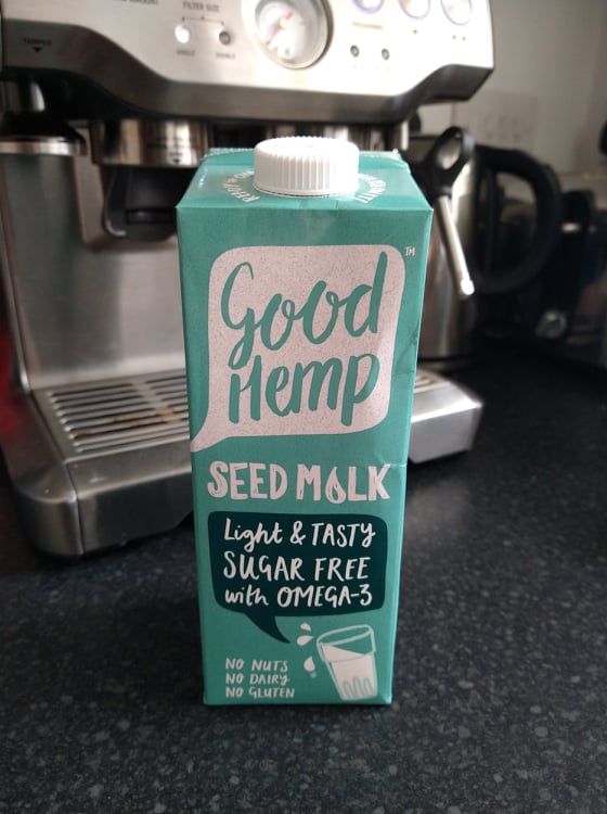 A turquoise carton of Good Hemp see milk in front of our Sage coffee machine.