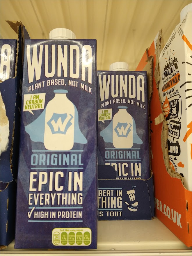 Dark blue cartons of Wunda milk on the shelf in Tesco.