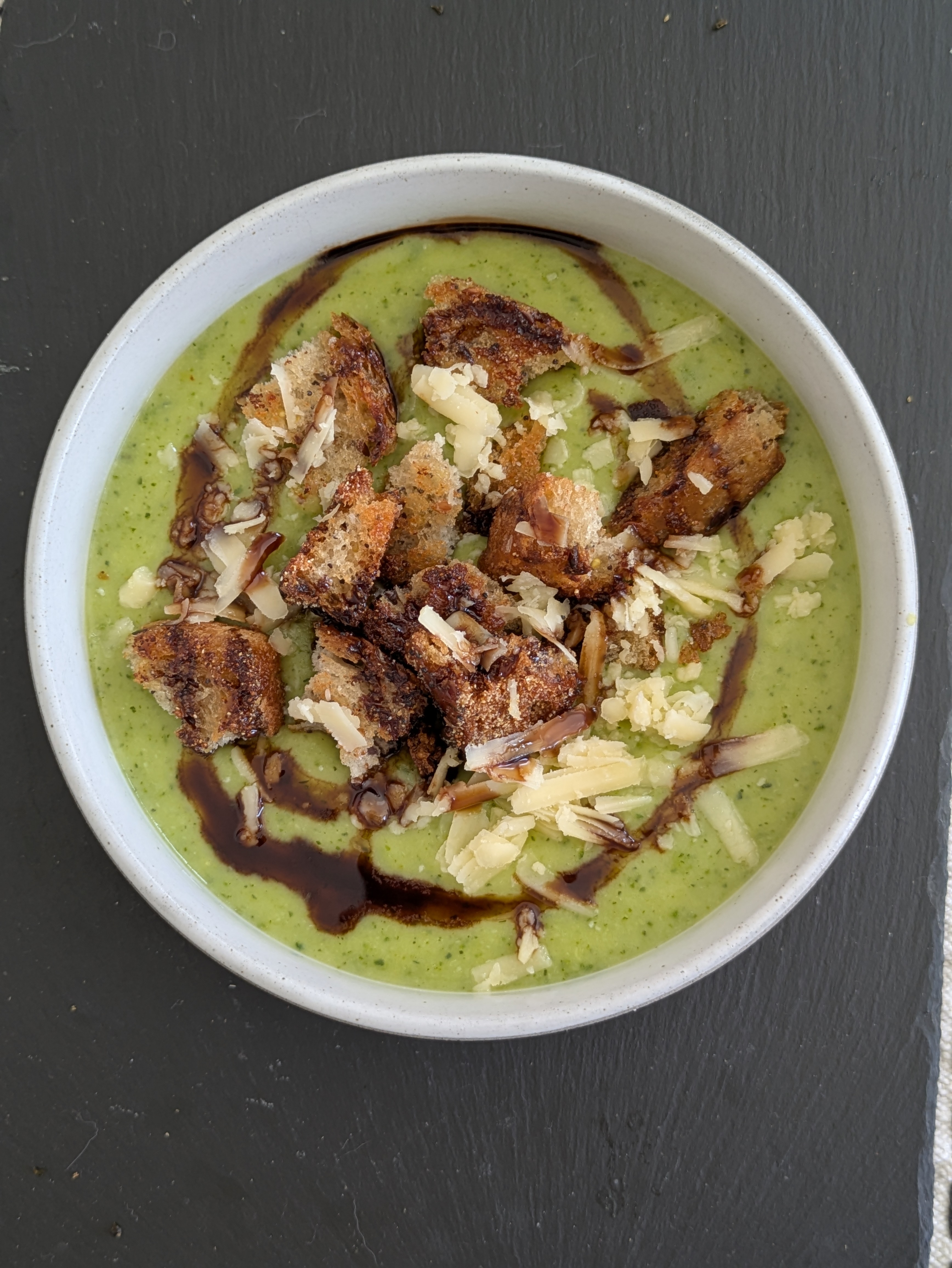 Crispy croutons in a bowl of green courgette and potato soup!