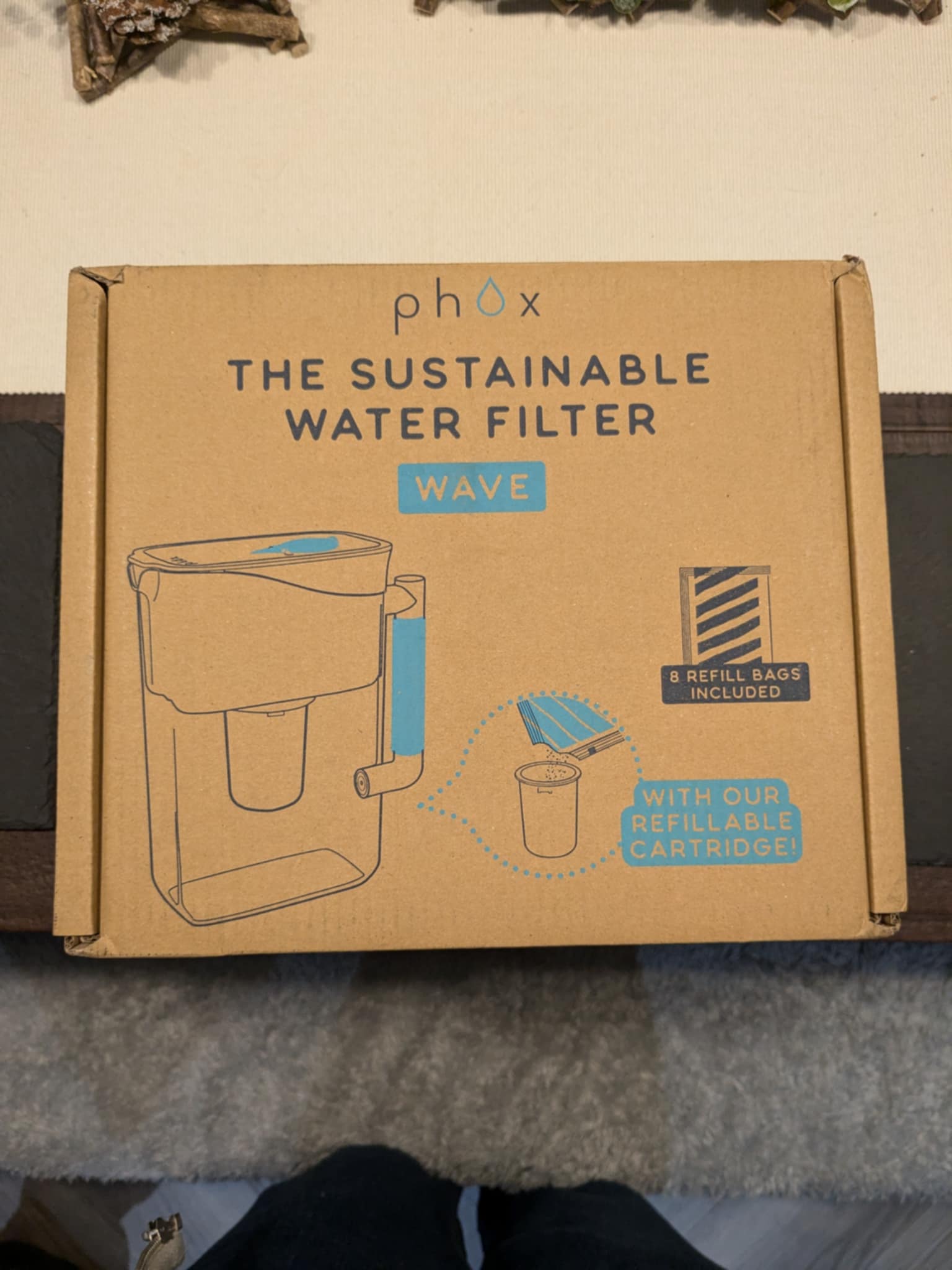 The Phox water filter in its cardboard box packaging.